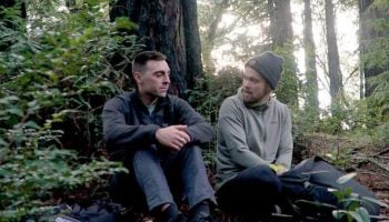 two men talking in the woods