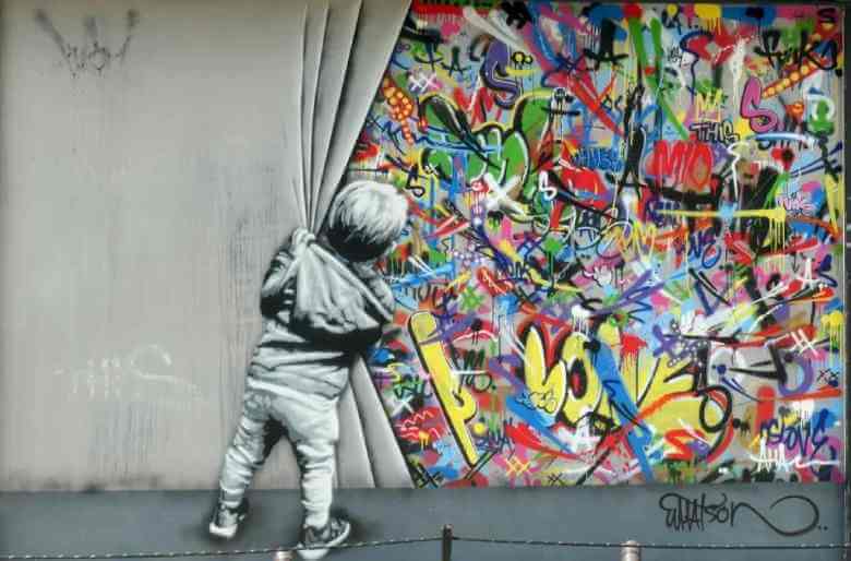 black and white boy discovering colored graffiti