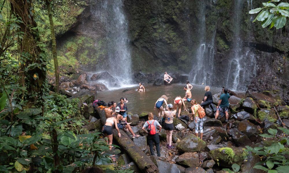 group of people visiting waterfall