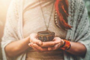 woman holding plant medicine cup - third wave blog image
