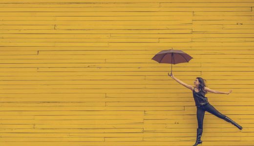 girl with umbrella on a yellow background