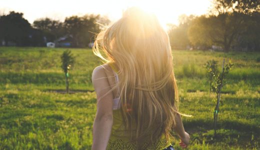 girl walking with the sun in front of her